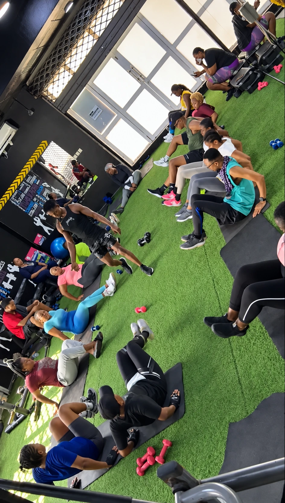 Coach leading members through floor exercises in a Fitness Arcade group class
