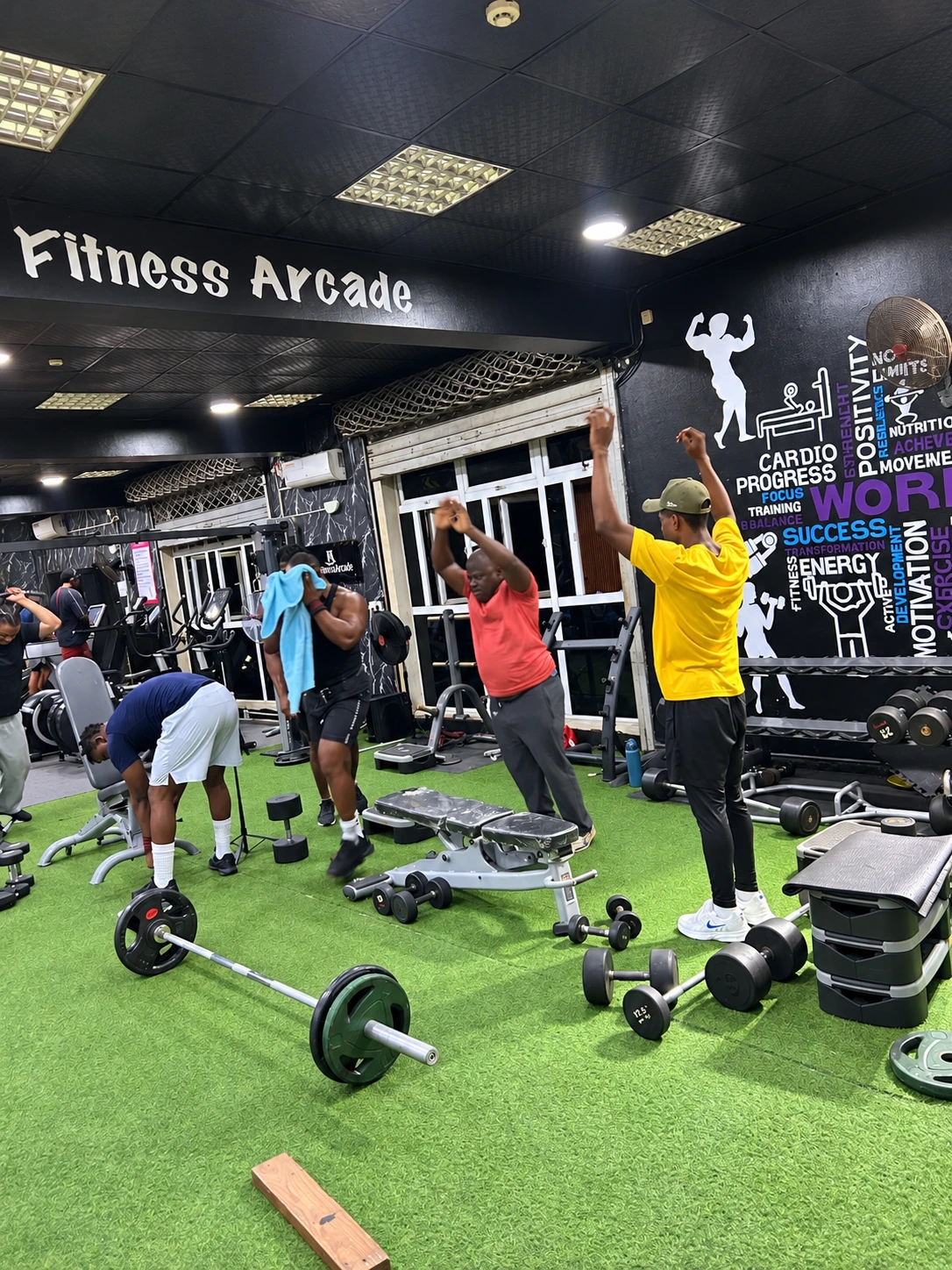 Coach and members exercising on the Fitness Arcade gym floor