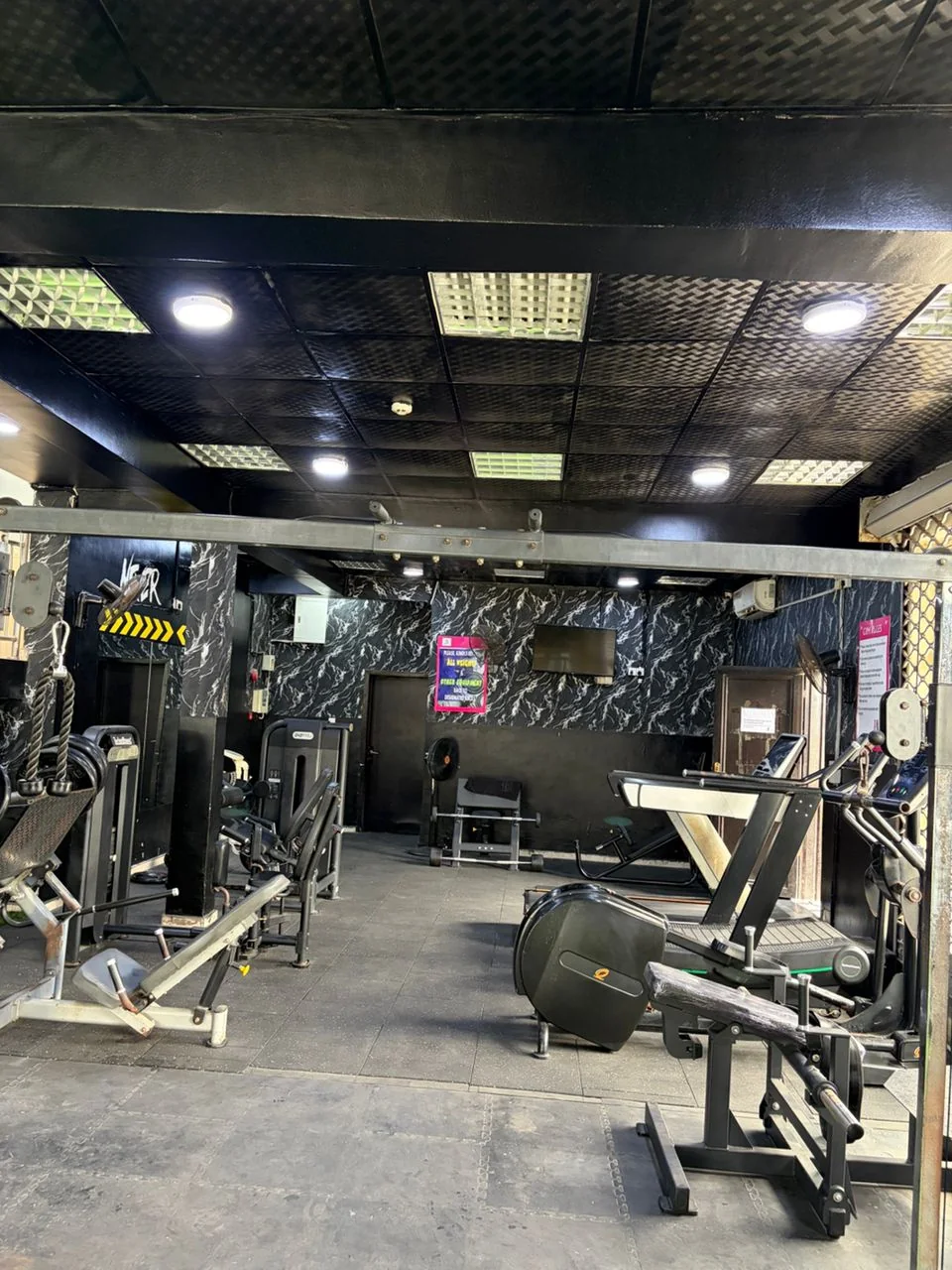 Strength machines and free weights on the Fitness Arcade gym floor
